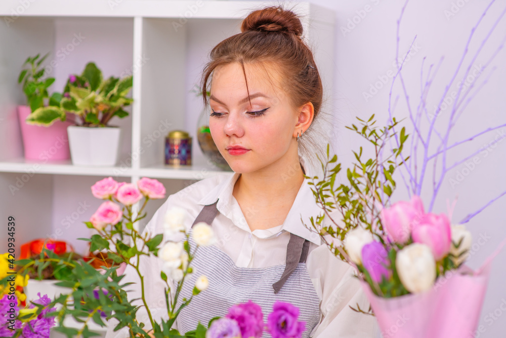 Smiling Woman Florist Small Business Flower Shop Owner. Happy woman gardener with flower Smiling Woman Florist Small Business Flower Shop Owner. Happy woman gardener with flower