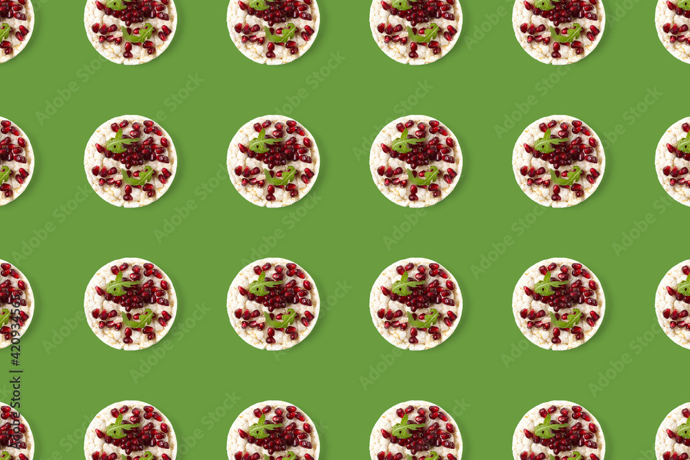 Abstract background from galett. Healthy breakfast with rice cake and pomegranate on black flat lay. Pop art Abstract background from galett. Healthy breakfast with rice cake and pomegranate on black flat lay. Pop art