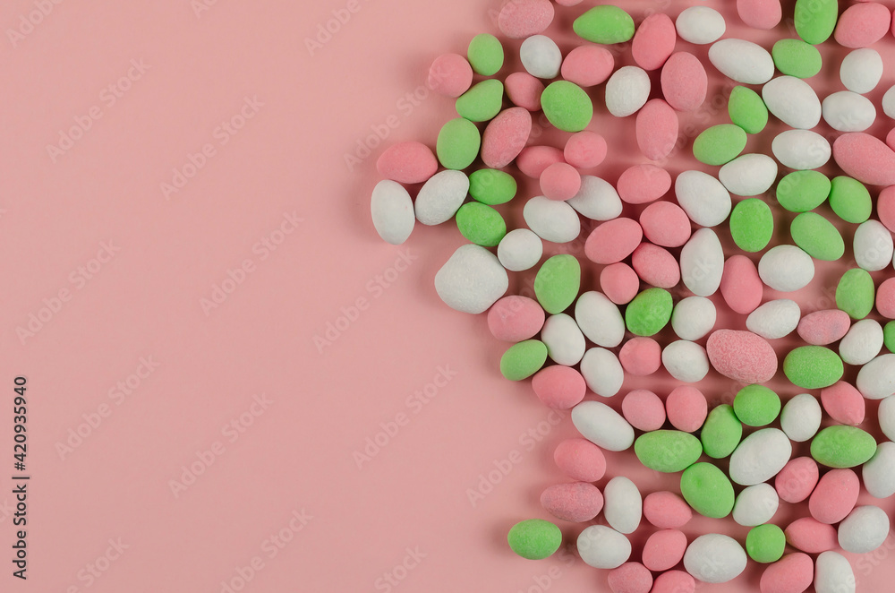 Sweet Dragee scattered on a pink background. Sweet Dragee scattered on a pink background.