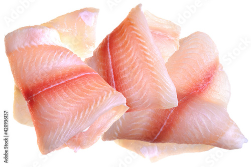 Pangasius fish fillet, pieces on a green lettuce leaf. Isolated on a white background. Fresh Fish Fillet.