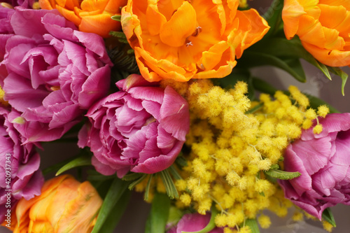 Wedding flowers, bridal bouquet closeup. Decoration made of mimosa, tulips and decorative plants. Spring flowers for background