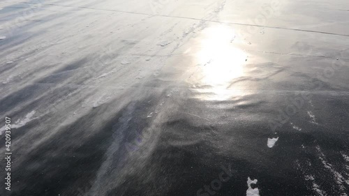 Heavy wind drives the wind across the frozen ice surface of Lake Baikal. Siberia, Russia
