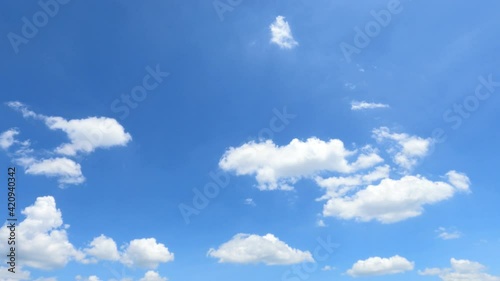 Puffy fluffy white cloud n cotton candy cumulus cloudscape moving on beautiful sunny clear blue sky background in summer sunlight n sun ray at sunshine day, slow motion 4k cinemagraph b-roll TimeLapse