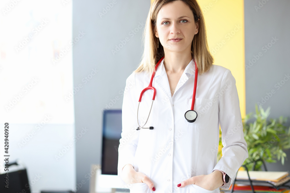 Portrait of female doctor with stethoscope around her neck in clinic Portrait of female doctor with stethoscope around her neck in clinic