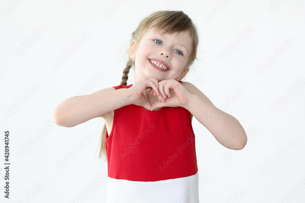 Little girl showing heart shape with her hands Little girl showing heart shape with her hands