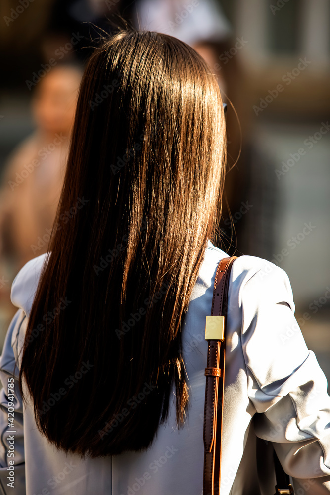 Fototapeta premium Asian girl with long hair in the background, exposed to the sun