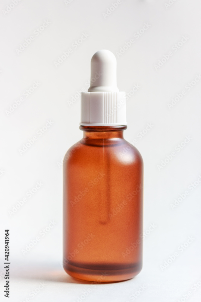 Bottle with serum on white background close-up, front view Bottle with serum on white background close-up, front view