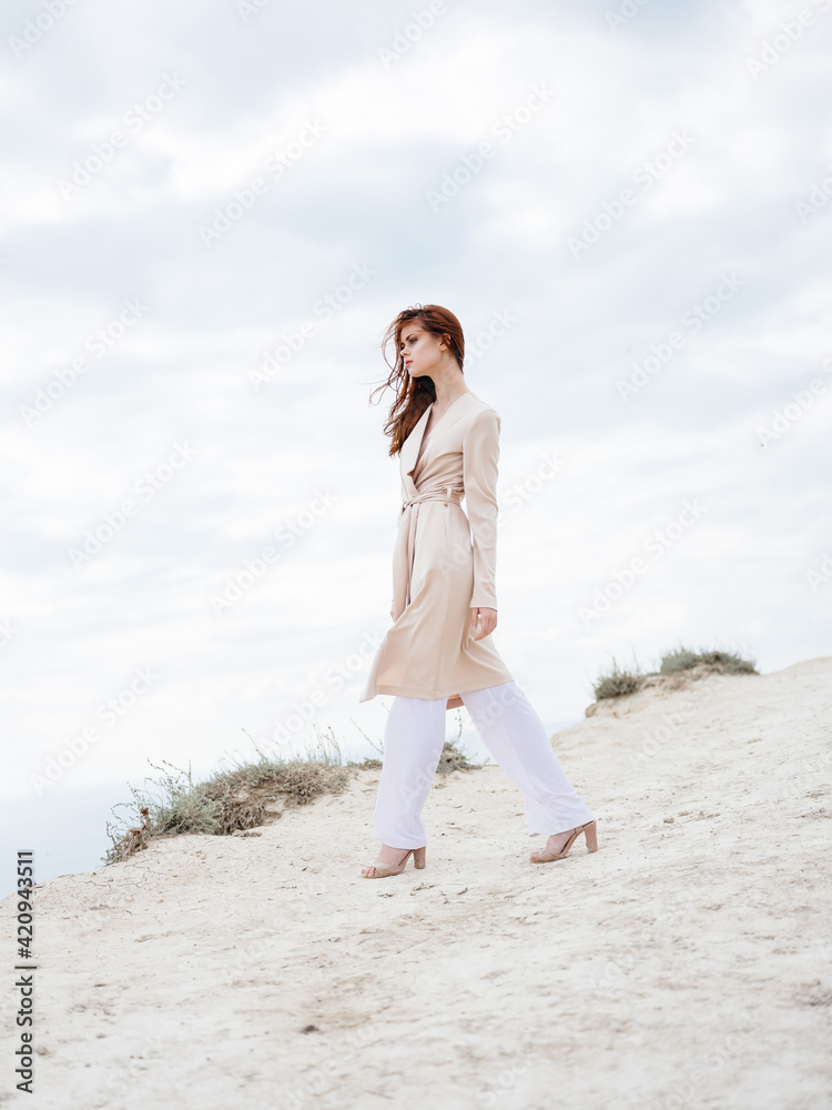 Woman wearing light clothes in full growth in nature and sand model shoes Woman wearing light clothes in full growth in nature and sand model shoes
