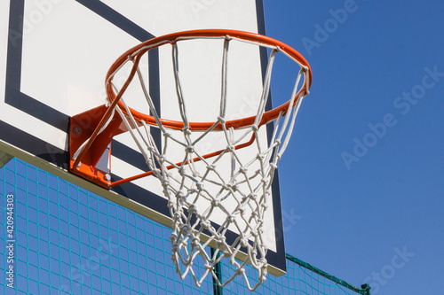 Basketball board with hoop. Sport and recreation time © ratmaner