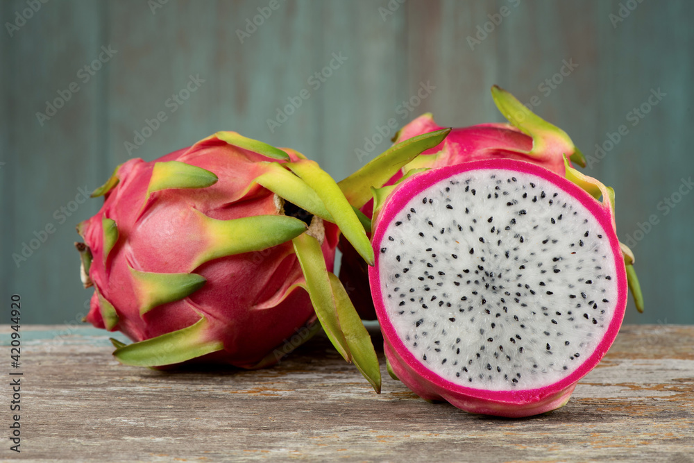Dragon fruits isolated on an old wood background. Dragon fruits isolated on an old wood background.
