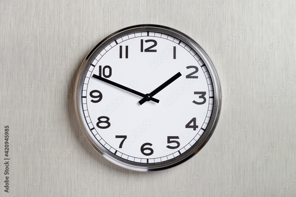 Plain wall clock in the center of grey textured background. Two o'clock. Close up banner with copy space, time management or business concept and lunch time. Opening or closing hours. Schedule Plain wall clock in the center of grey textured background. Two o'clock. Close up banner with copy space, time management or business concept and lunch time. Opening or closing hours. Schedule
