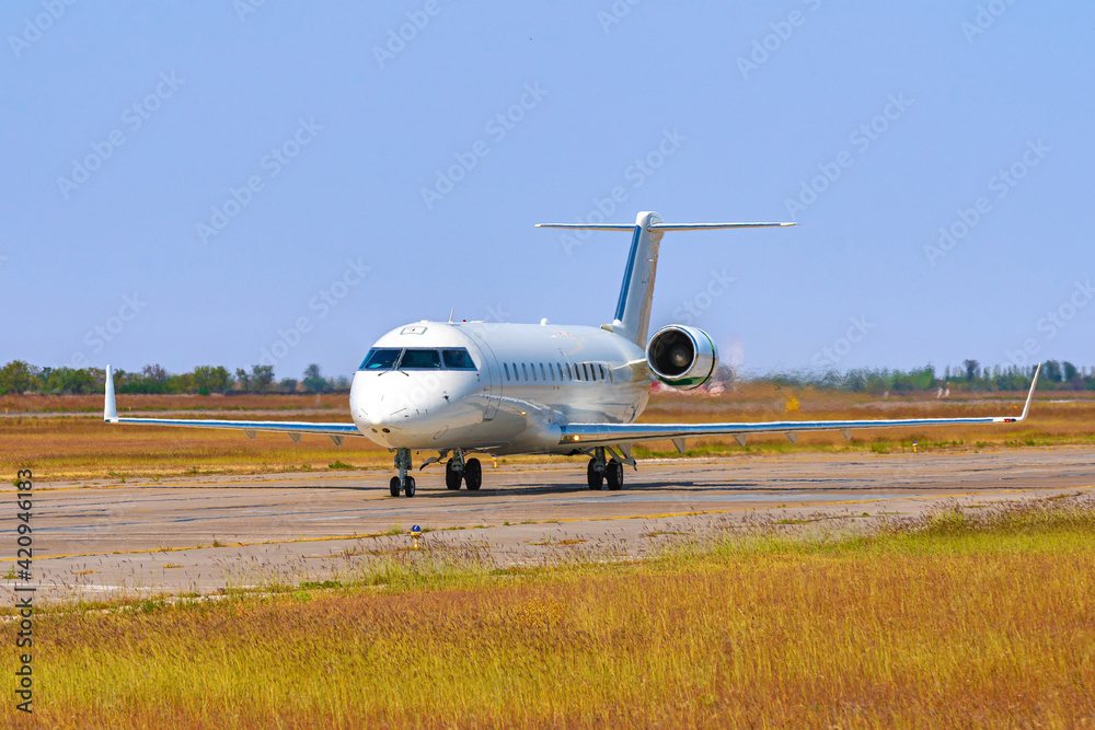 Big passenger airplane drives along the runway in airport Big passenger airplane drives along the runway in airport