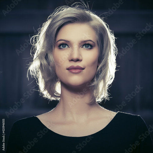 Happy young fashion blond woman in black dress