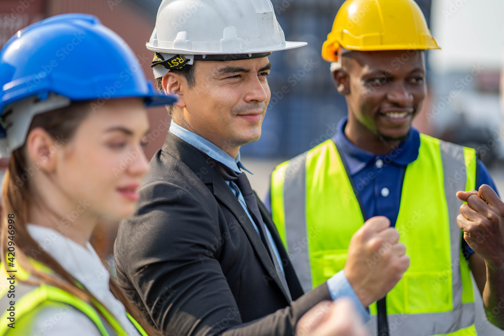 The team of engineers happily and congratulated the accomplishment. business, building, industry, technology and people concept. The team of engineers happily and congratulated the accomplishment. business, building, industry, technology and people concept.