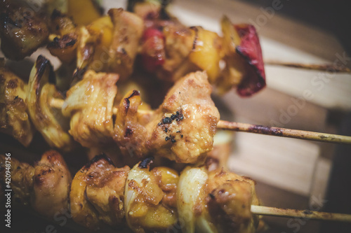 Close up image of traditional chicken kebabs or sosaties that was cooked on a braai in south africa photo