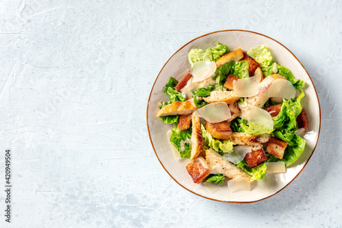Fototapeta Caesar salad with chicken meat, top shot