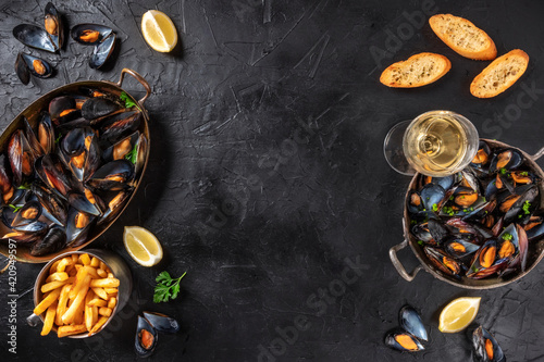 Mussels with wine, lemon, and French fries, overhead flat lay shot