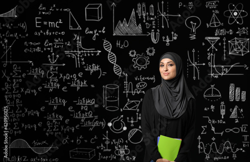 Female Arab student near bl...