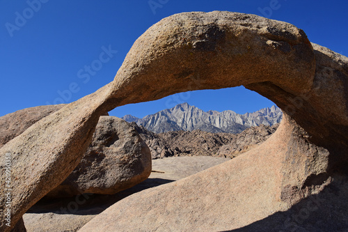 mount whitney and the eastern sierras, as seen through mobius arch  on a sunny fall day near lone pine, california photo