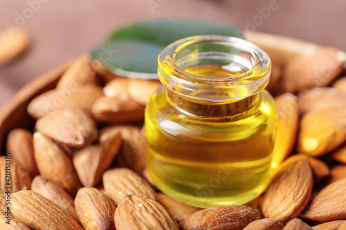 Bottle of almond oil and nuts, closeup