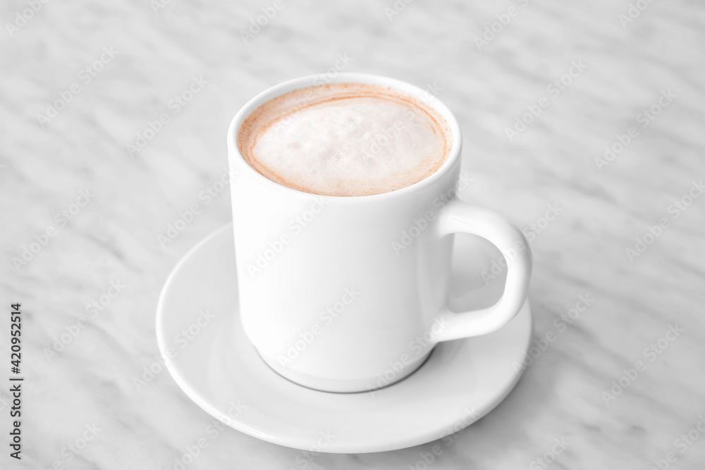 Obraz premium Cup of tasty latte on light background