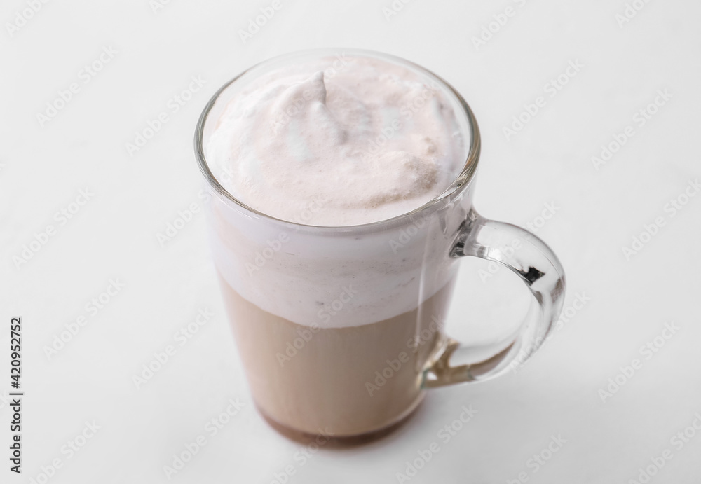 Glass cup of tasty latte on light background Glass cup of tasty latte on light background