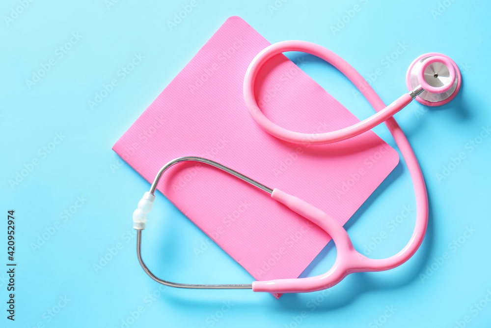 Stethoscope and notebook on color background Stethoscope and notebook on color background