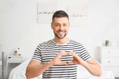 Man making heart with his h...
