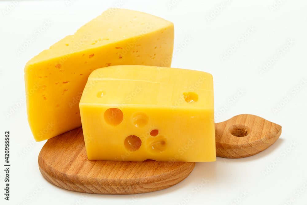 Cheese on wooden cutting board on white background Cheese on wooden cutting board on white background