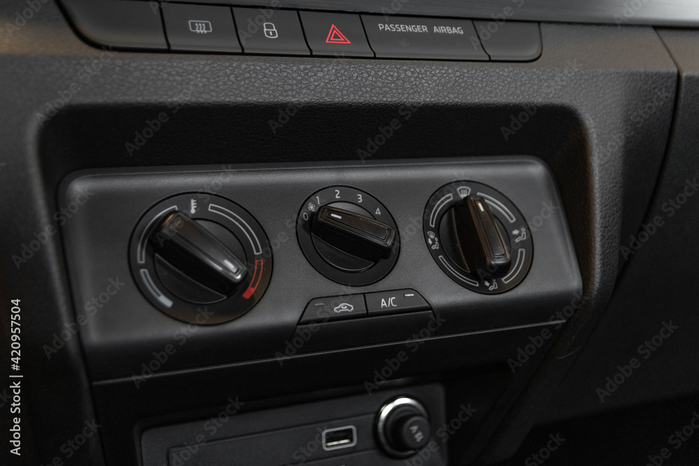Fototapeta premium interior view of a modern new car. Climatronic or air conditioner system button.German Car.