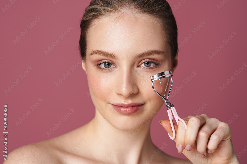 Portrait of young beautiful woman with eyelash curler Portrait of young beautiful woman with eyelash curler