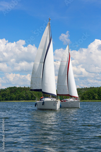 Fototapeta Naklejka Na Ścianę i Meble -  Lake in Polish Masuria, sailing yachts on a sunny day, Masuria, Poland