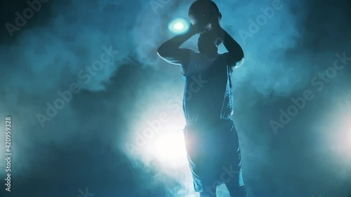 African american player is throwing a basketball in slow motion