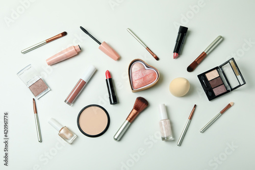 Different makeup cosmetics on white background, top view