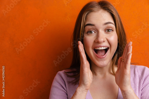 Quadro em tela Young ginger excited woman looking and screaming at camera