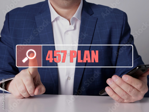  457 PLAN text in search line. Manager looking for something at smartphone. 457 PLAN concept. photo