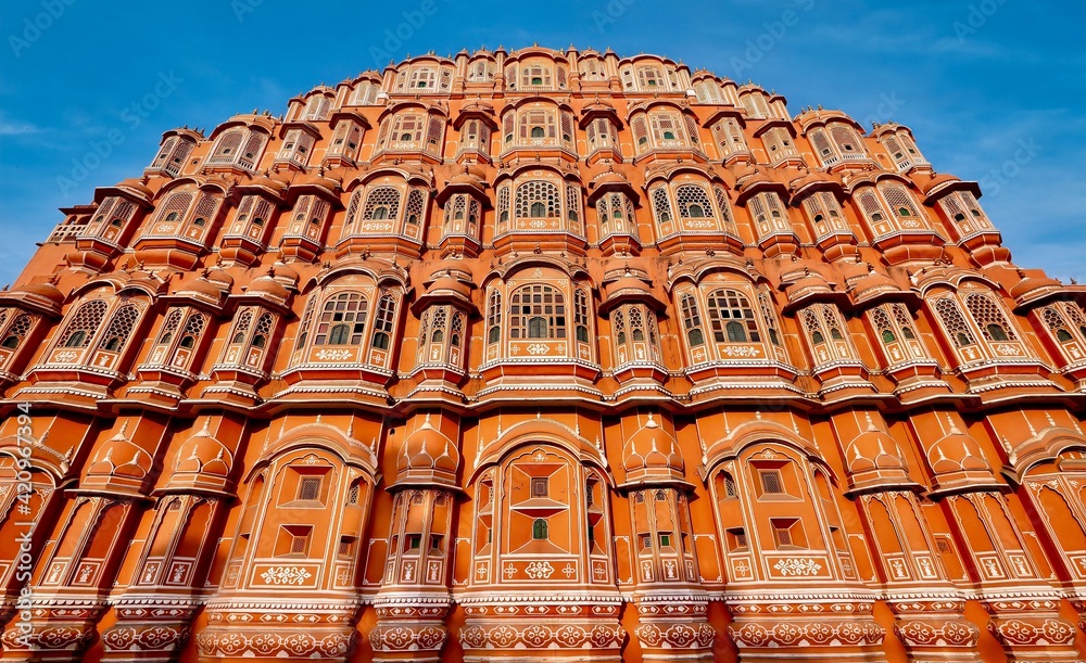 Street view of the ornate front facade of the historic Hawa Mahal, or Palace of the Winds, in Jaipur, India, built in 1799.