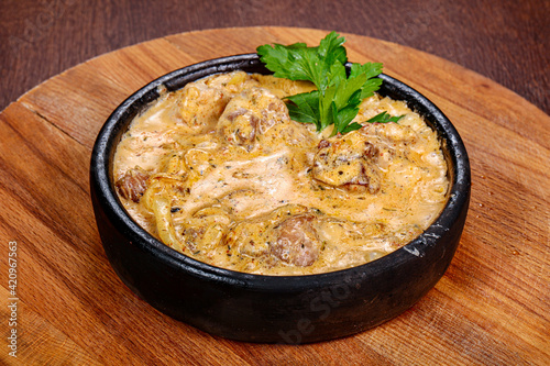 Pork with cream sauce in the pot