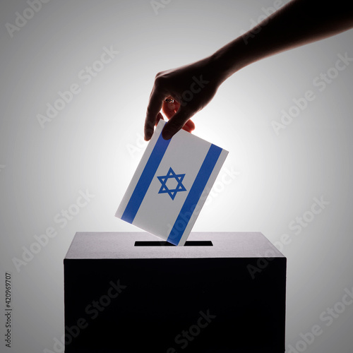 Fotografie Close-up of Israeli voter putting ballot into voting box.