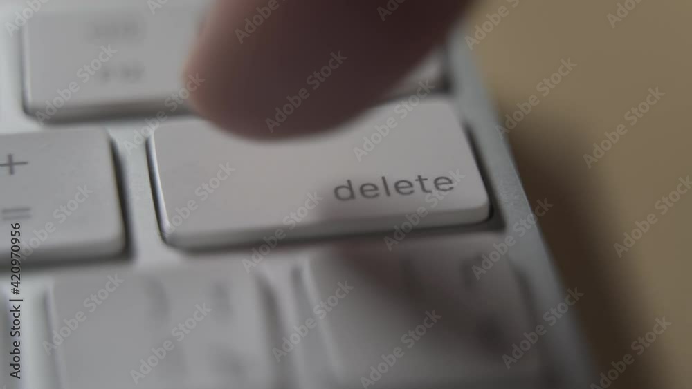  Close up of white computer keyboard and delete button.