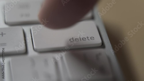  Close up of white computer keyboard and delete button.