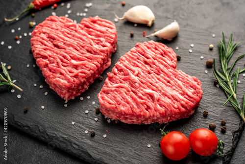 minced meat in the shape of a heart on a stone background