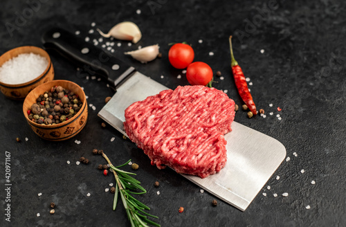 heart shaped minced meat on a knife on a stone background
