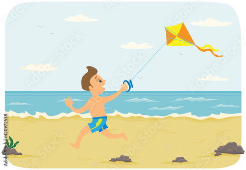 Boy on beach having fun and playing with colorful air toy. Child running after kite along shore