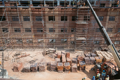 Construction site of multi-storey building with concrete slabs and columns. Men at work .
