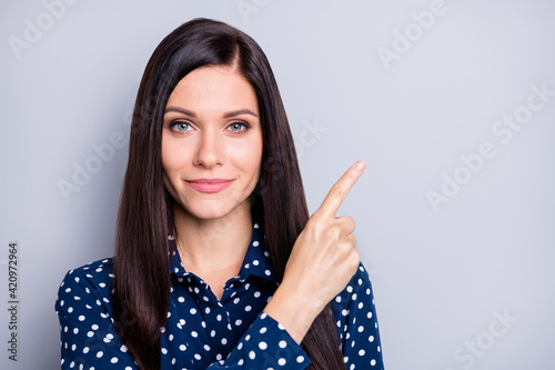 Quadro su tela Portrait of optimistic good brunette girl point empty space wear blue blouse iso
