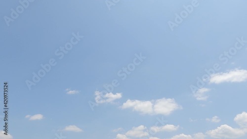Puffy fluffy white cloud n cotton candy cumulus cloudscape moving on beautiful sunny clear blue sky background in summer sunlight n sun ray at sunshine day, slow motion 4k cinemagraph b-roll TimeLapse