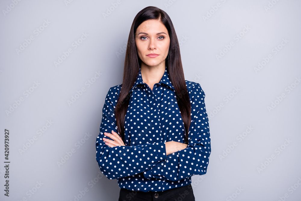 Photo of strict brunette girl crossed arms wear blue blouse isolated on grey color background Photo of strict brunette girl crossed arms wear blue blouse isolated on grey color background