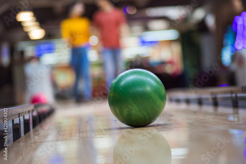 Couple playing bowling. Focus on ball.