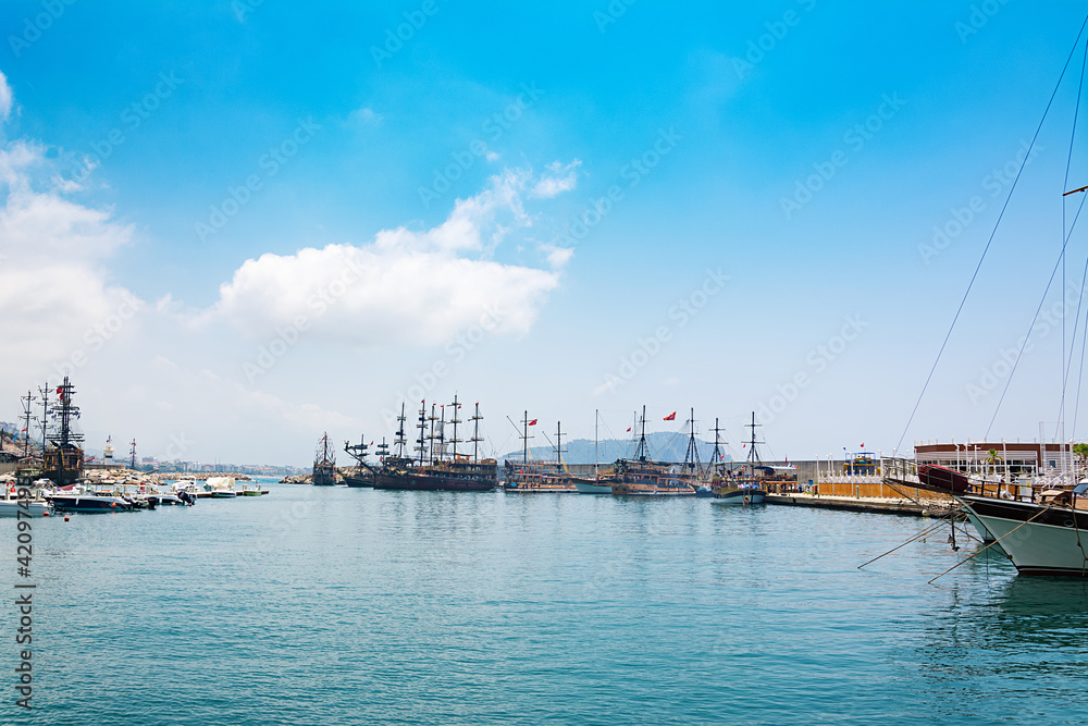 View of boats yachts and tourist galleons moored in old marina or port harbor at Mediterranean sea.  Turkey